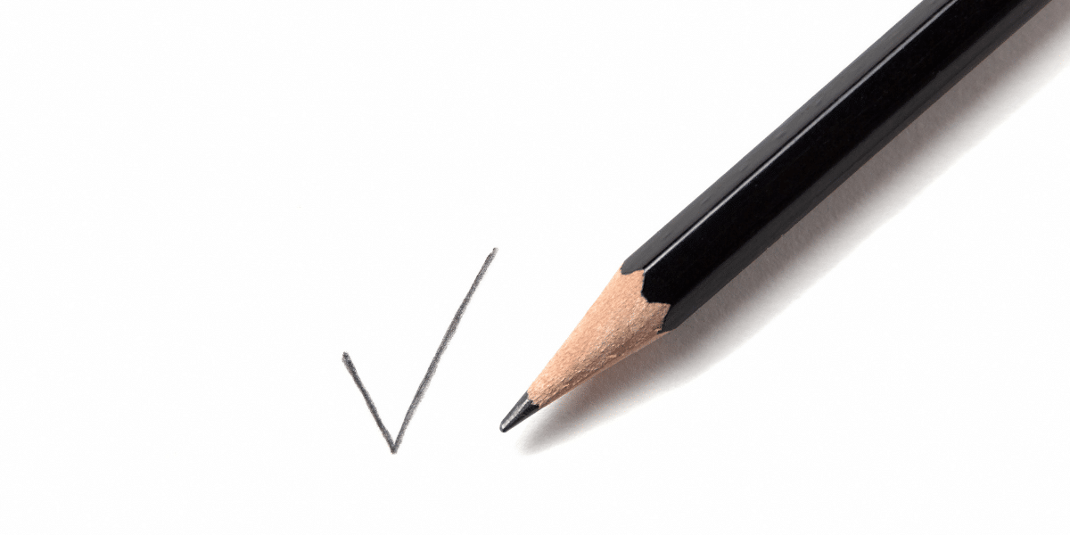 a pencil drawing a checkmark